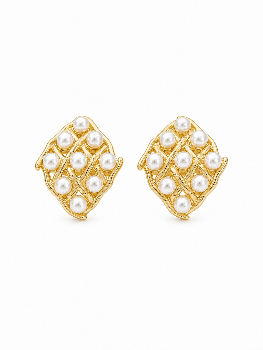 A pair of gold and pearl stud earrings with a diamond-shaped design, set against a plain white background.